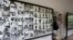 A tourist walks past photos of former prisoners displayed at Tuol Sleng genocide museum, a former Khmer Rouge prison known as S-21, in Phnom Penh.
