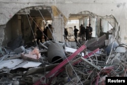 Palestinians inspect the damage to a school sheltering displaced people, after it was hit by an Israeli strike, at Beach camp in Gaza City, Nov. 7, 2024.