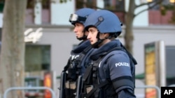 After a shooting armed police officers patrol on a street at the scene in Vienna, Austria, Nov. 3, 2020. 
