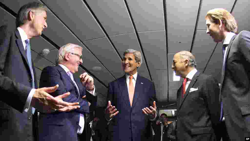 French Foreign Minister Laurent Fabius (2nd right), German Foreign Minister Frank-Walter Steinmeier (2nd left), British Foreign Secretary Philip Hammond (left), U.S. Secretary of State John Kerry (center), and Austrian Foreign Minister Sebastian Kurz (right) talk prior to their final plenary meeting at the United Nations building in Vienna, Austria, July 14, 2015.