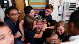 Joe Emery, TAC*ONE trainer and former Las Vegas police department sergeant, is swarmed by fifth grade students in a shooter take down exercise at Pinnacle Charter School during TAC*ONE training for an active shooter situation in a school in Thornton, Colo