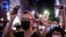 FILE - Pro-democracy protesters hold up their mobile phone torches as they sing during a rally in the Causeway Bay district of Hong Kong on June 12, 2020.
