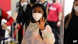 Simone Biles and the US Women's Gymnastics team arrive for the Tokyo 2020 Summer Olympic Games at Narita International Airport, July 15, 2021, in Narita, east of Tokyo. 