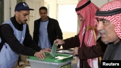 A man casts his ballot at a polling station in Amman, January 23, 2013. 