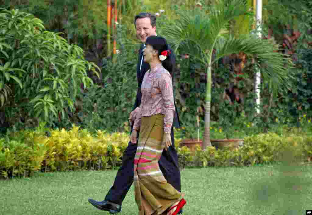 British Prime Minister David Cameron and Aung San Suu Kyi share a light moment during their meeting in the compound of her lakeside home, April 13, 2012, Rangoon, Burma.