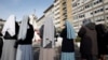 Nuns pray outside the Gemelli Hospital where Pope Francis is admitted for treatment, in Rome, Italy, Feb. 23, 2025. 