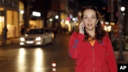 Dutch-Turkish journalist Ebru Umar talks on her mobile phone in Kusadasi, Turkey, Monday, April 25, 2016. Umar, a columnist for The Netherlands' Metro newspaper, has been barred from leaving Turkey. 