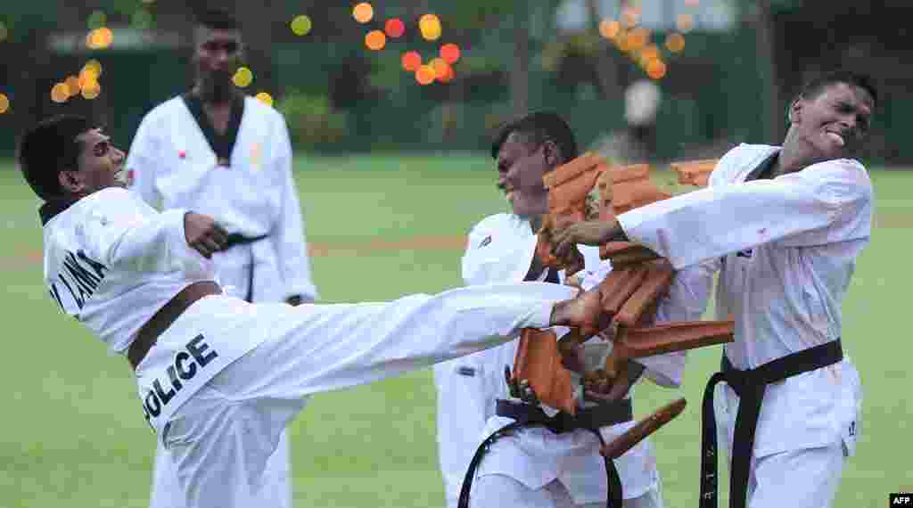 Sri Lankan policemen take part in a drill during a ceremony marking the 148th anniversary of the police department in Colombo.