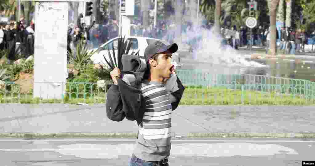 A protester gestures to police during clashes in Tunis, Feb. 6, 2013. 