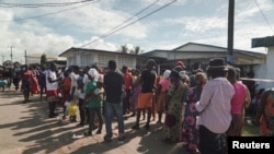 People wait in line to cast their vote for Liberia's presidential election in Monrovia, Liberia October 10, 2023. 