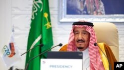 In this handout image from the Saudi Royal Palace, Saudi King Salman gives his opening remarks at a virtual G-20 summit hosted by Saudi Arabia and held via videoconference amid the COVID-19 pandemic, in Riyadh, Saudi Arabia, Nov. 21, 2020.