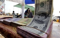 FILE - Banknotes are displayed on a roadside currency exchange stall along a street in Juba, Jan. 14, 2011.
