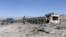 FILE - Afghan security forces inspect the aftermath of a suicide bomb blast in Gardez, Paktia Province, Afghanistan, June 18, 2017. 