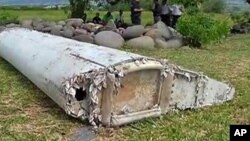 FILE - This image taken from video, shows a piece of debris from a plane, July 29, 2015, in Saint-Andre, Reunion. 