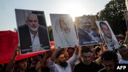 Pro-Palestinian demonstrators take part in a rally to condemn the assassination of Hamas leader Ismail Haniyeh, at Hagia Sophia Square in Istanbul, on August 3, 2024.