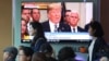 People pass by a TV screen showing a footage of U.S. President Donald Trump during a news program at the Seoul Railway Station in Seoul, South Korea, May 25, 2018. 