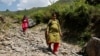 FILE - Bandhana Devi, a pregnant woman, walks down a mountain after voting at a remote polling station in Almi, India, on June 1, 2024, during a nationwide heatwave. The World Health Organization says that climate change threatens the health of pregnant women, among others.