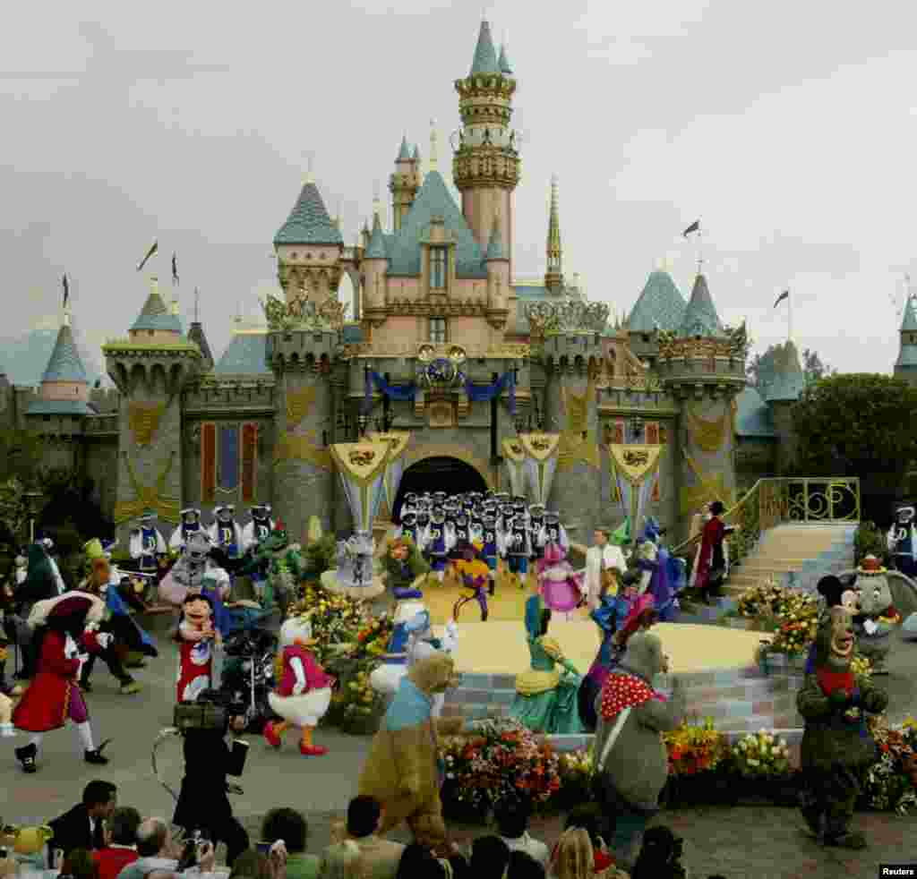 The stage is filled with Disney characters during the finale at Disneyland's 50th anniversary celebration ceremony, at the Disneyland theme park as "The Happiest Homecoming on Earth" begins in Anaheim, California May 5, 2005. Sleeping Beauty Castle (backg