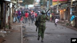 FILE - Opposition supporters run away from police during clashes after the election commission announced results from the Oct. 26 vote in the Kibera area of Nairobi, Kenya, Oct. 30, 2017. 