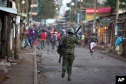 Opposition supporters run away from police during clashes after the election commission announced results from the Oct. 26 vote in the Kibera area of Nairobi, Kenya, Oct. 30, 2017.