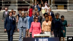 House Speaker Nancy Pelosi of Calif. and House Democrats arrive for a news conference on the first 200 days of the 116th Congress at the House East Front steps of the Capitol building, in Washington, July 25, 2019.