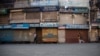 Kashmiris walk at a closed market during a strike by separatists on the second anniversary of India’s revocation of the disputed region’s semiautonomy in Srinagar, Indian-controlled Kashmir, Aug. 5, 2021. 