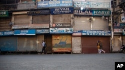Kashmiris walk at a closed market during a strike by separatists on the second anniversary of India’s revocation of the disputed region’s semiautonomy in Srinagar, Indian-controlled Kashmir, Aug. 5, 2021. 