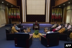 Myanmar's State Counsellor Aung San Suu Kyi (C) holds talks with leaders from the United Nationalities Federal Council (UNFC) at the National Reconciliation and Peace Centre (NRPC) in Yangon on July 17, 2016.