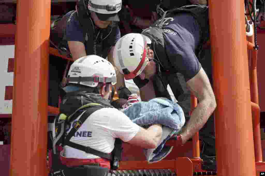 A newborn baby is carried onto the Ocean Viking humanitarian rescue ship after a rescue operation about 100 kilometers from the coast of Libya in the Mediterranean Sea.