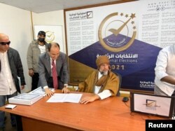 FILE - Saif al-Islam al-Gadhafi, son of Libya's former leader Moammar Gadhafi, registers as a presidential candidate for the December 24 election, at the registration center in the southern town of Sebha, Nov. 14, 2021.