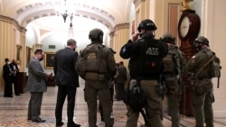 Police with the Alcohol, Tobacco and Firearms (ATF) maintain security in the halls of the Senate in the U.S. Capitol, as a joint session continues in the House to certify President-elect Joe Biden, in Washington, Jan. 6, 2021.