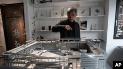 Pritzker Prize winner Chinese architect Liu Jiakun is seen with a scale model of the West Village project at his office in Chengdu, in southwestern China's Sichuan province, March 2, 2025.