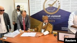 Seif al-Islam Gaddafi, son of Libya's former leader Moammar Gadhafi, registers as a presidential candidate for the December 24 election, at the registration center in the southern town of Sebha, Nov. 14, 2021. 