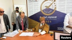 Saif al-Islam al-Gaddafi, son of Libya's former leader Moammar al-Gadhafi, registers as a presidential candidate for the December 24 election, at the registration centre in the southern town of Sebha, Nov. 14, 2021. 