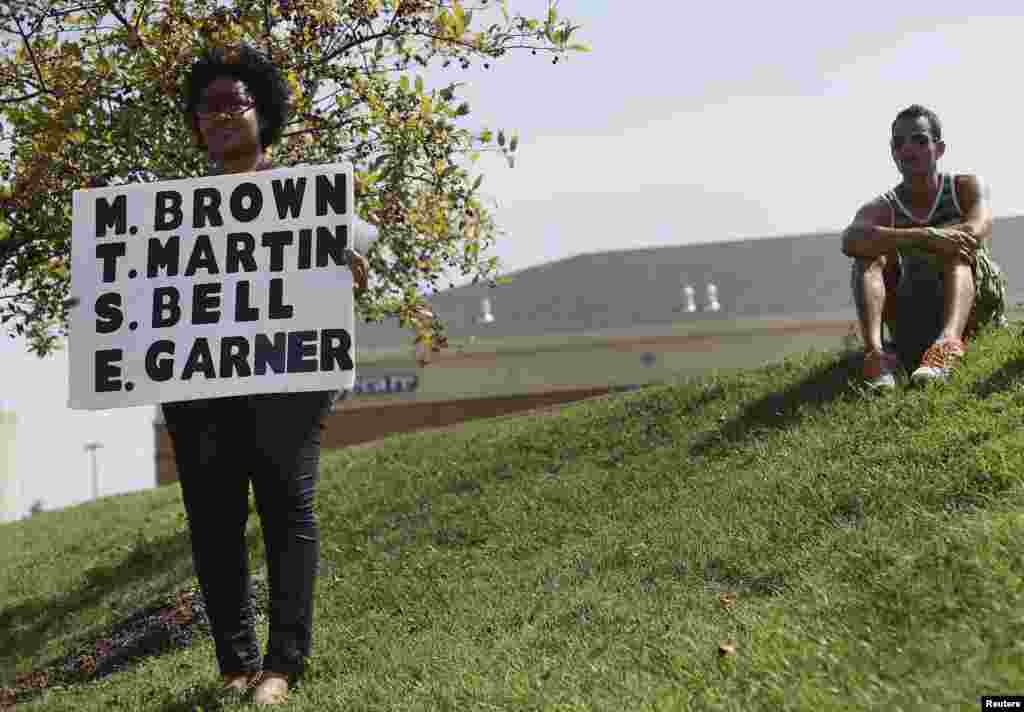 A demonstrator protesting the shooting of Michael Brown holds a sign in Ferguson, Missouri Aug. 23, 2014. 