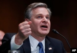 FILE - FBI Director Christopher Wray testifies during a hearing on Capitol Hill, May 16, 2018.