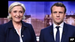 French presidential election candidate for the Front National party, Marine Le Pen, left, and French presidential election candidate for the En Marche! movement, Emmanuel Macron, appear before their debate Wednesday May 3.
The two face each other in a run-off election on May 5.