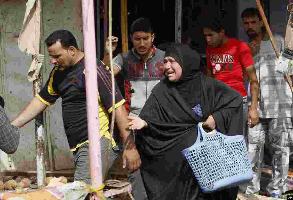 Civilians react at the site of a car bomb attack in front of a crowded popular restaurant in Basra, Iraq, May 20, 2013.