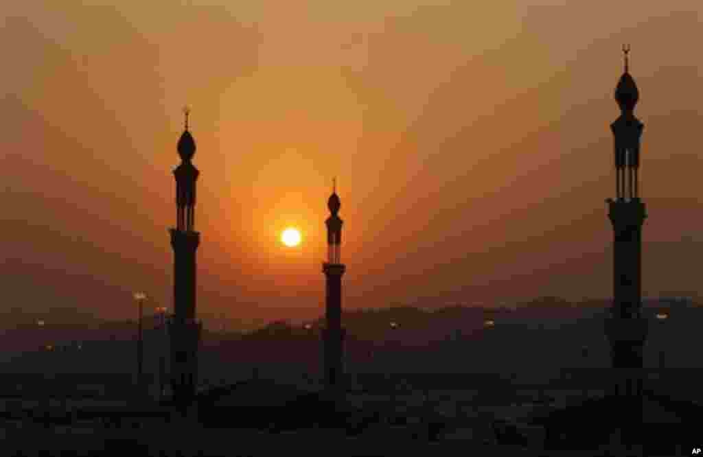 The minarets of Namira mosque are seen during prayers at sunset in Arafat near Mecca, Saudi Arabia, Monday, Nov. 15, 2010. The annual Islamic pilgrimage draws 2.5 million visitors each year, making it the largest yearly gathering of people in the world.