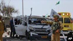 Israeli soldier walks past a car hit by a missile fired from Gaza near the Gaza and Israel border, Sunday, May 5, 2019. Palestinian militants on Saturday fired over 200 rockets into Israel, drawing dozens of retaliatory airstrikes on targets across the Gaza Strip. (AP)