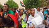 Sudanese protesters shout slogans and carry banners as they march in the capital Khartoum, on June 3, 2021, during a demonstration calling for justice for protesters killed during anti-government demonstrations two years ago.