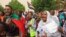 Sudanese protesters shout slogans and carry banners as they march in the capital Khartoum, on June 3, 2021, during a demonstration calling for justice for protesters killed during anti-government demonstrations two years ago.