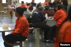 FILE - Detainees are seen at the Otay Mesa immigration detention center in San Diego, Calif., May 18, 2018.