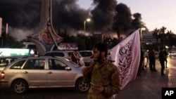 Smoke billows as people gather to celebrate the fall of the Syrian government, in Damascus, Syria, Dec. 8, 2024.