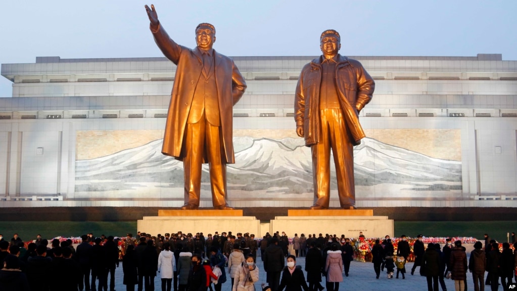 Citizens visit the bronze statues of their late leaders Kim Il Sung, left, and Kim Jong Il on Mansu Hill in Pyongyang, North Korea Thursday, Dec. 16, 2021, on the occasion of 10th anniversary of demise of Kim Jong Il. 