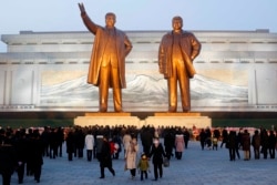 FILE - Citizens visit the bronze statues of their late leaders Kim Il Sung, left, and Kim Jong Il on Mansu Hill in Pyongyang, North Korea Thursday, Dec. 16, 2021, on the occasion of 10th anniversary of demise of Kim Jong Il.