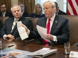 FILE- US President Donald Trump shows a letter he said was from North Korean leader Kim Jong-un during a Cabinet meeting at the White House in Washington, DC, on January 2, 2019.