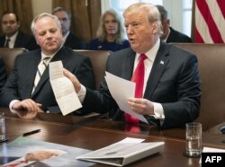 FILE- US President Donald Trump shows a letter he said was from North Korean leader Kim Jong-un during a Cabinet meeting at the White House in Washington, DC, on January 2, 2019.