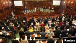 Kosovo’s newly elected members of parliament take the oath as parliament convenes for the first time since the June snap election, in Pristina, Kosovo Aug. 3, 2017.