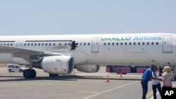 FILE - In this photo taken Feb. 2, 2016, a hole is seen in a plane operated by Daallo Airlines as it sits on the runway of the airport in Mogadishu, Somalia.